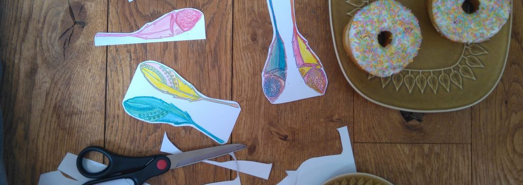 cutting out Free printable boho feathers pdf for a doughnut party diy craft