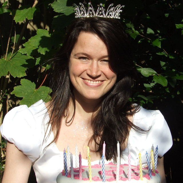 blogger ulla lake dressed as a princess holding a cake