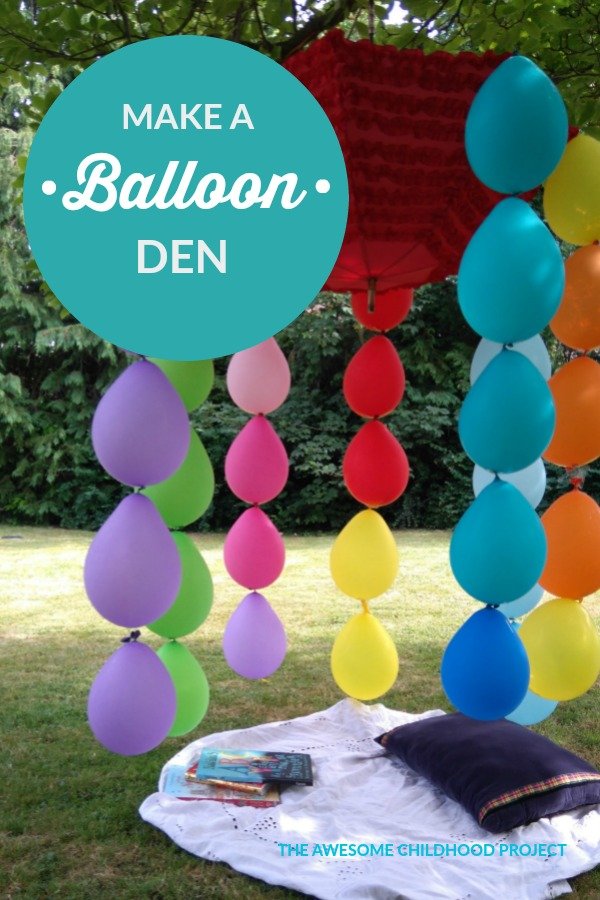 compostable balloons trailing from an upside down umbrella in a tree for a garden party
