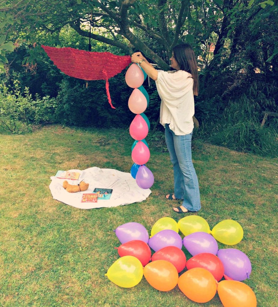 Ulla Lake making a garden party balloon den in a tree