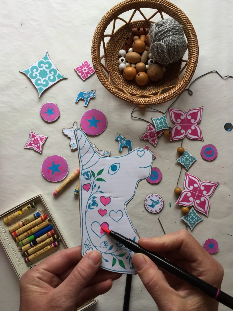 colour in the unicorn head shapes from the free unicorn printable kids art activity