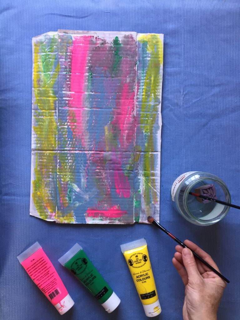 paint a colourful pattern on cardboard to make recycled cardboard nature necklaces with kids