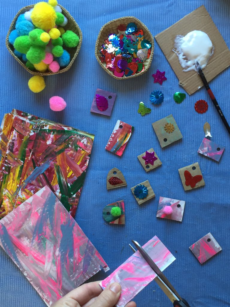 kids create colourful and eco friendly necklaces from cardboard shapes, paint, sequins and nature