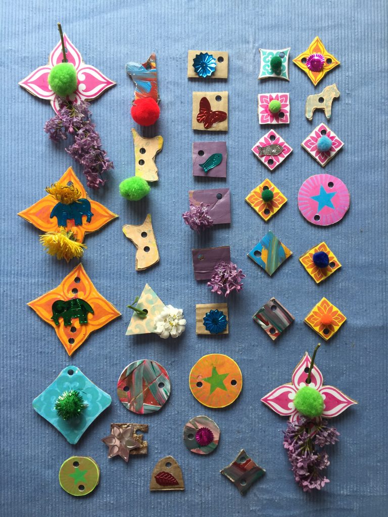 create a colourful selection of kids recycled cardboard art threadable shapes with flowers and unicorns