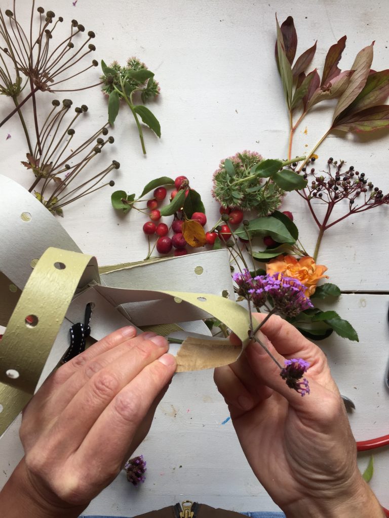 attach the stems of your foliage to the back of the fascinator card strips with tape