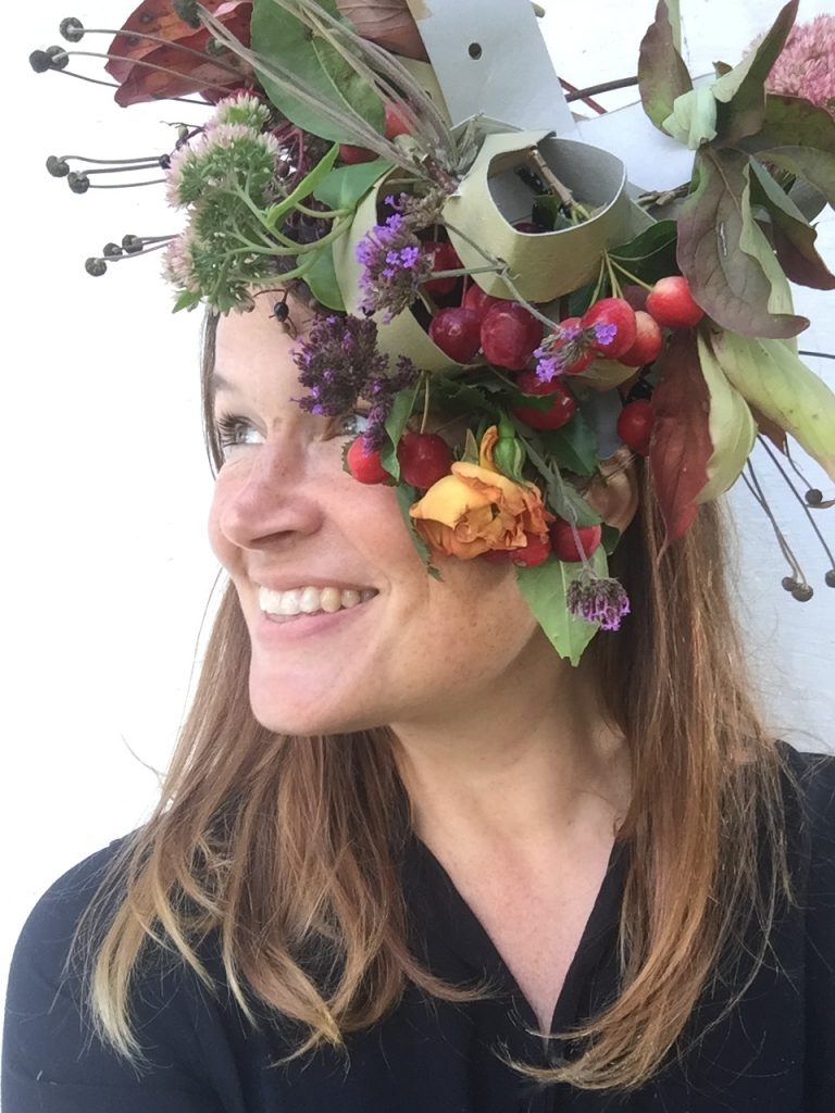 Ulla Lake from the awesome childhood project blog wearing a floral autumn fascinator made from a pizza box and foliage